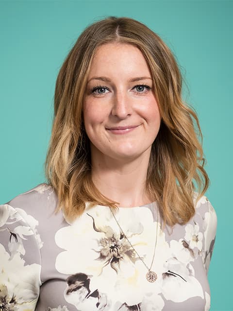 Headshot of Hannah in a white top